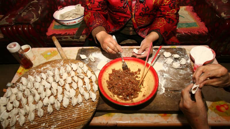 Food is an important part of the celebrations. Here, dumplings are prepared Lunar New Year.