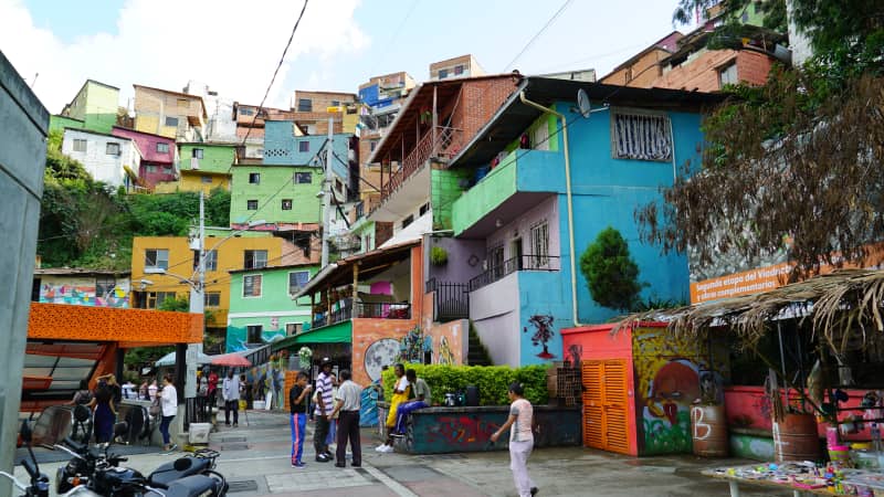 Colorful houses and food stalls line the Medellín streets.