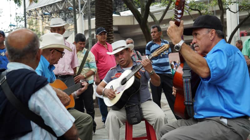 A group of locals play bambuco, traditional folk music originating from Colombia.