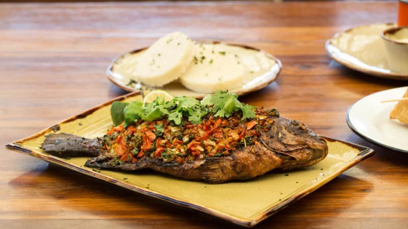 Kenyan food is a treat. This is oven-baked whole tilapia with roasted tomato and dhania salsa 