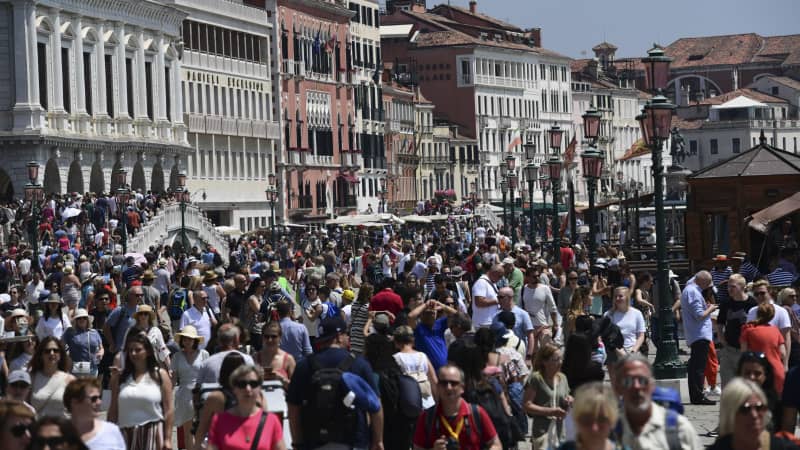 A picture taken close to San Marco square on June 8, 2019 shows tourists visiting Venice. 
