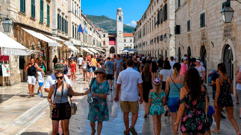 Tourists stroll in a street as they visit the centre of Dubrovnik 