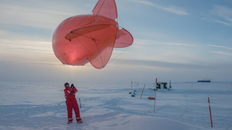 A Leibniz Institute for Tropospheric Research team member operating a helium-filled balloon in Greenland, 2018. Horvath followed the years of preparations which led to the MOSAiC expedition finally departing in September 2019.