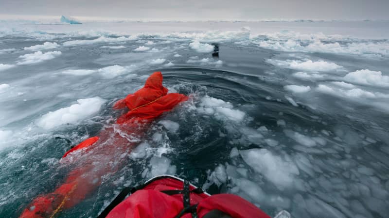 British polar explorer Anne Daniels swimming between ice floes on her way to the Geographic North Pole in 2010. Reaching the North Pole is becoming harder on foot, says Hartley (the last successful expedition from land was in 2014). 