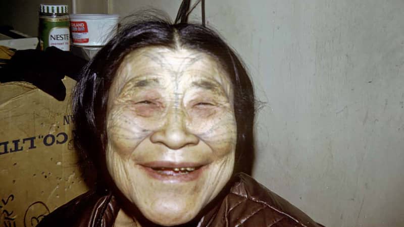 An Inuit woman with traditional tattoos on her face smiles in this 1969 archival photo from Canada's north.