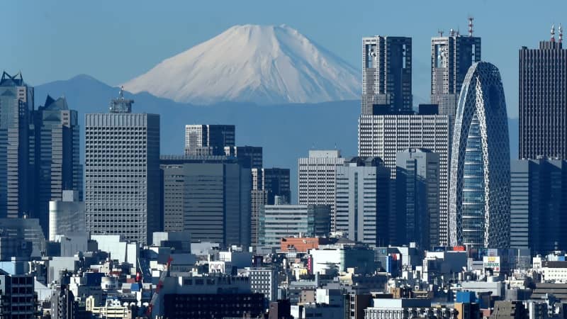 A snow-covered Mount Fuji is seen behind Tokyo in this file photo from 2014. 