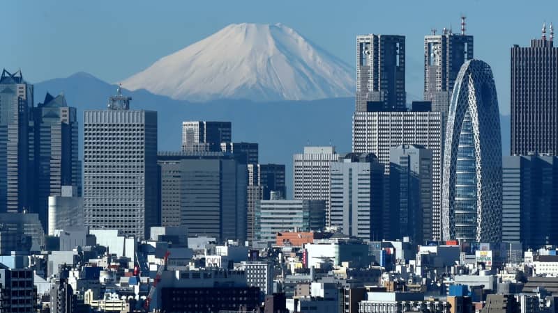 A snow-covered Mount Fuji is seen behind Tokyo in this file photo from 2014. 