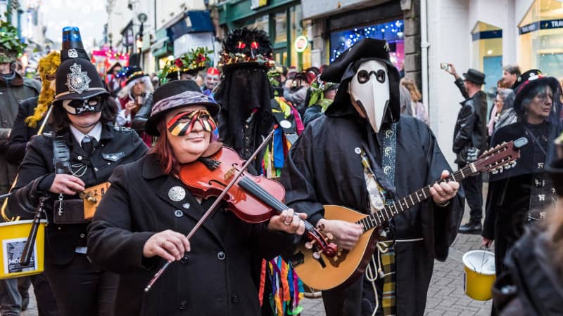 Have a rousing good time at The Montol Festival in Penzance, England.
