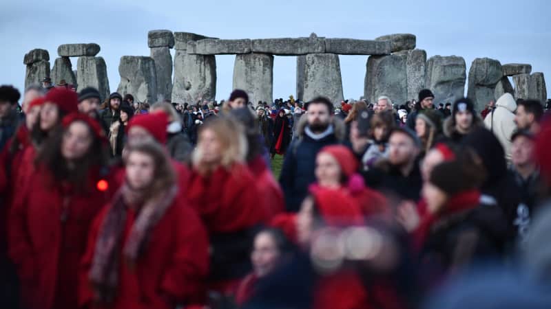 A choir sings at Stonehenge to mark the winter solstice. In-person visits are canceled for 2020, however.