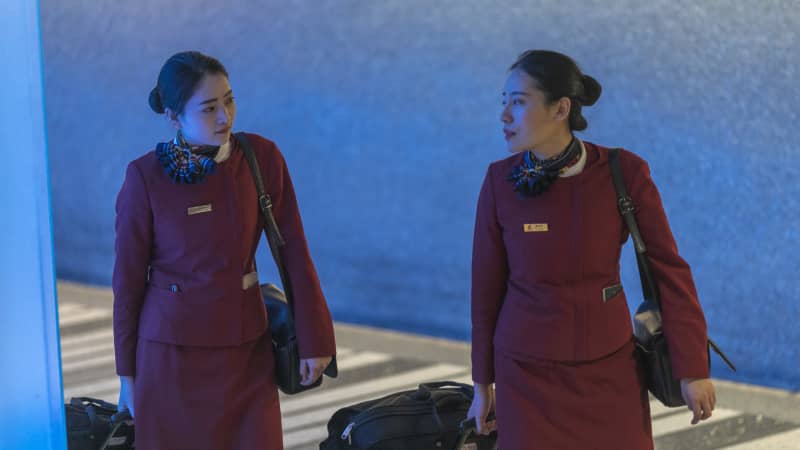 Air China flight attendants arrive at Los Angeles International Airport after touchdown from Beijing, which serves as a connector from Wuhan, on the first day of health screenings for coronavirus.