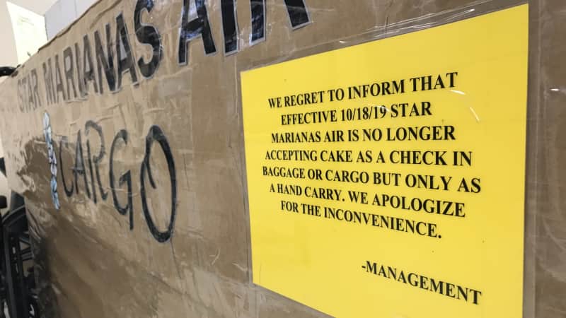 A sign at the Tinian airport cargo desk lets passengers know they can't ship cakes as cargo.