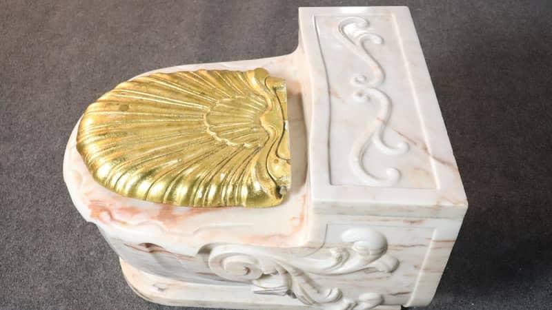 This gold-seated toilet sold for $4,250 at auction. 