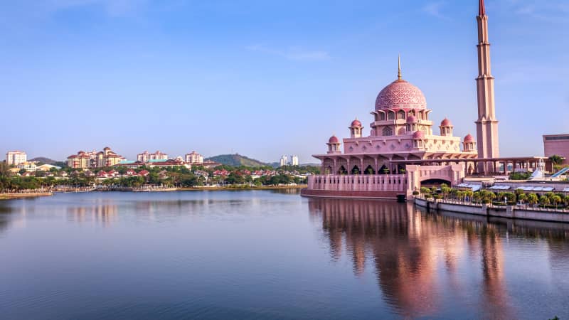 Putra Mosque in Putrajaya, Malaysia, is located at the edge of a manmade lake.