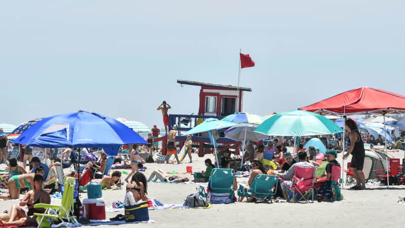 People enjoy the sun and sand at Lori Wilson Park in Cocoa Beach Saturday, May 2, 2020 after the park reopened to visitors.
