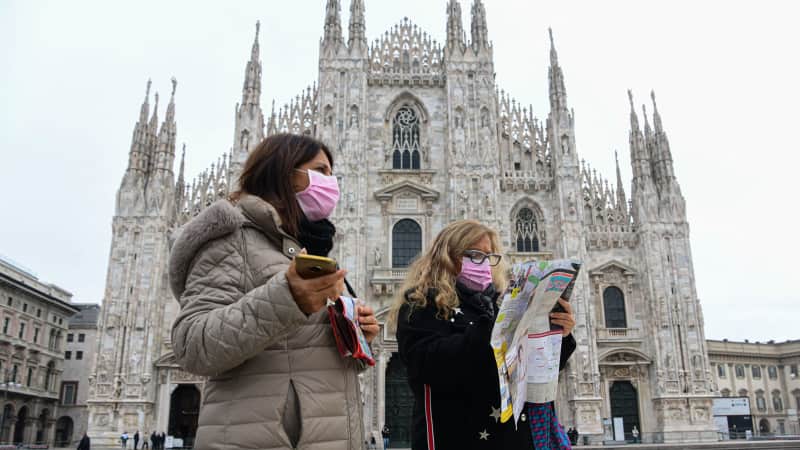 Tourists wearing masks in Piazza Duomo in Milan, on March 5. 2020