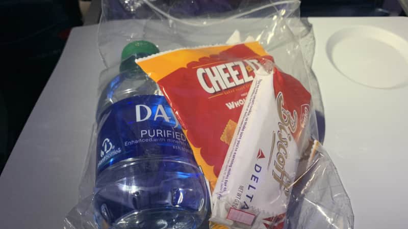Snack pack with Cheez-Its, water, Biscoff cookies and Purell.