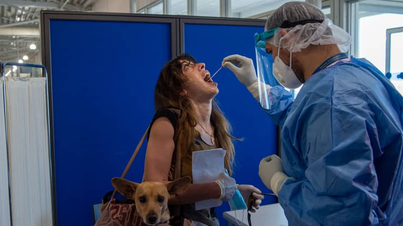 Medical staff conduct a Covid test on passengers at Eleftherios Venizelos International Airport on June 15, 2020 in Athens,