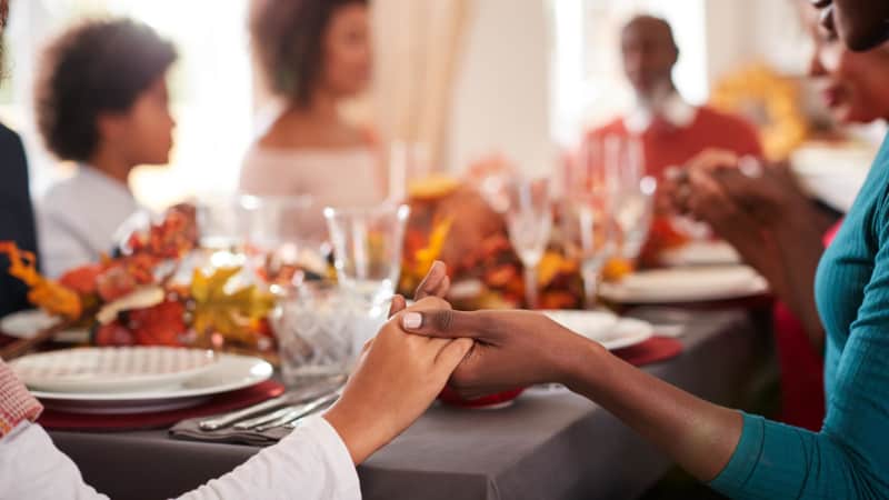 Joining hands around a crowded holiday table is best skipped this year.