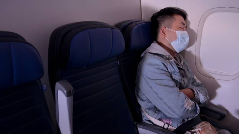 Wear a mask that covers your mouth and nose throughout your flight and stay seated as much as possible.