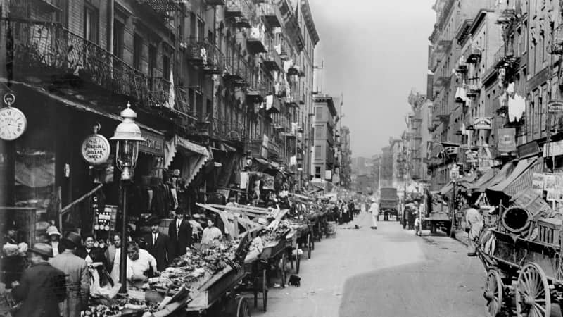 1900: An Italian neighborhood street market on Mulberry Street in New York City. 