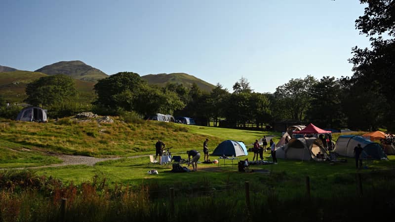 Campers wake in the early morning in the camp site beside Buttermere Lake in the Lake District in north west England on August 14, 2020.