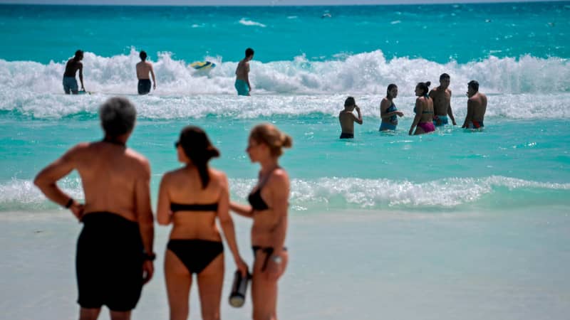 Mexico's international tourism income dropped by more than half in 2020. Here, people enjoy the beach in Cancun in October 2020. 