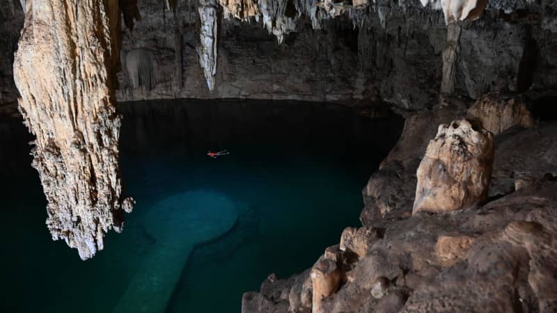 Tourists swim in the Cenote Suytun in Valladolid, Yucatan state, on December 15, 2020. 