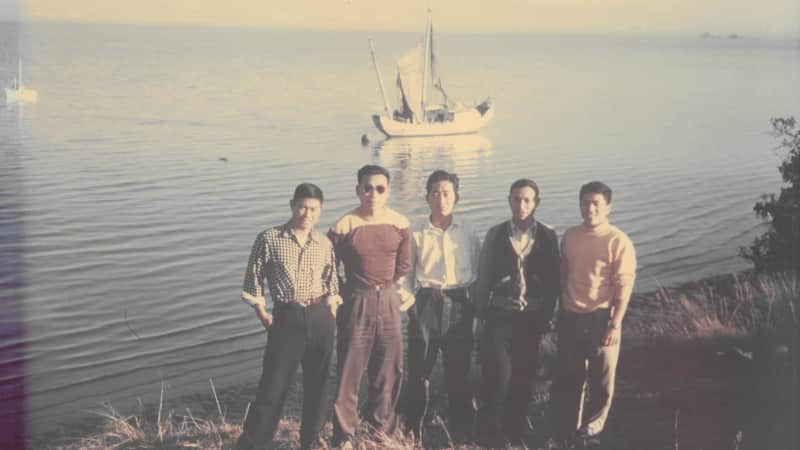 The five Chinese members of the crew pose in front of their boat after arriving in the US. 