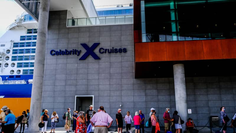 People stand in line as they prepare to board the Celebrity Edge cruise ship in Fort Lauderdale, Florida, on June 26, 2021.