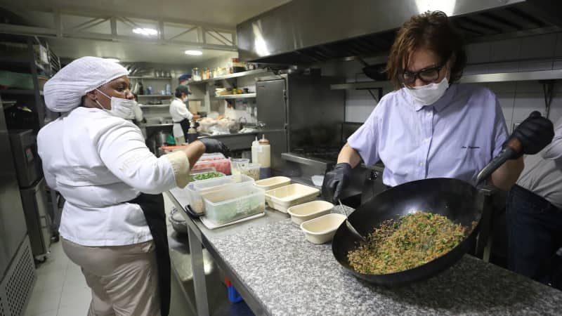 Chef Leonor Espinosa stirs a rice dish in the kitchen of her namesake restauranta LEO.