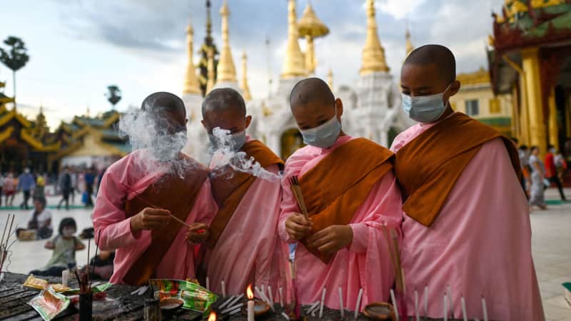 Nuns light incense sticks at Shwedagon Pagoda during the Thadingyut festival. 