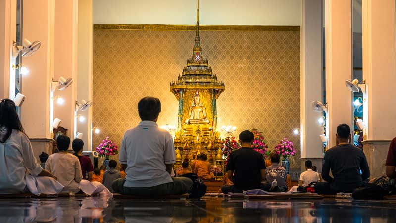 People meditate in a central Bangkok temple. 