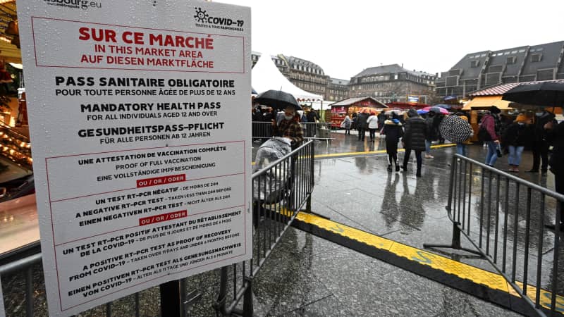 Customers have health passes checked before entering the traditional Christmas market in Strasbourg, France, on December 4, 2021.