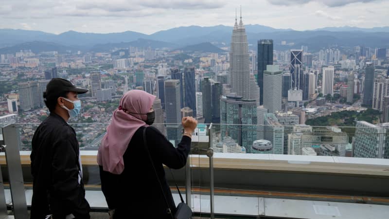 Tourists wearing face masks view from an observation deck at the Kuala Lumpur Tower in Kuala Lumpur, Malaysia.