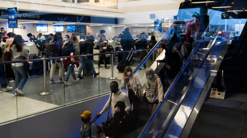 Travelers crowd the United Airlines check-in area at the Los Angeles International Airport on Wednesday, November 24, 2021. 