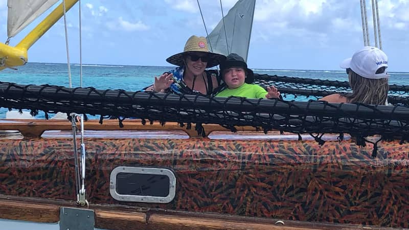 Mathias Pascal and his mother, Aline, enjoy a ride on a traditional boat in Moorea, French Polynesia.