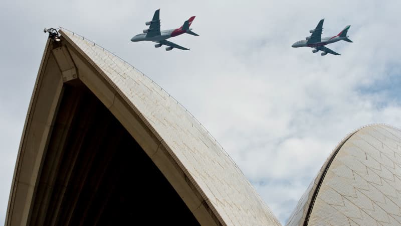 SYDNEY, AUSTRALIA - MARCH 31: (NO SALES, NO ADVERTISING) In this handout image provided by Qantas, A Qantas Airbus A380 and Emirates Airbus A380 fly over Sydney Harbour on March 31, 2013 in Sydney, Australia. The two Airbus A380s display is believed to be the first of its kind between two seperate airlines to fly over Sydney's Harbour which will mark the alliance between the two airlines. (Photo by James Morgan/Qantas via Getty Images)