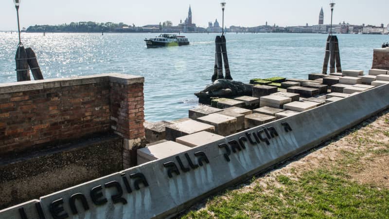 The tourist went for a swim in the lagoon, before lying down next to the statue of the murdered partisan, posing for pictures.