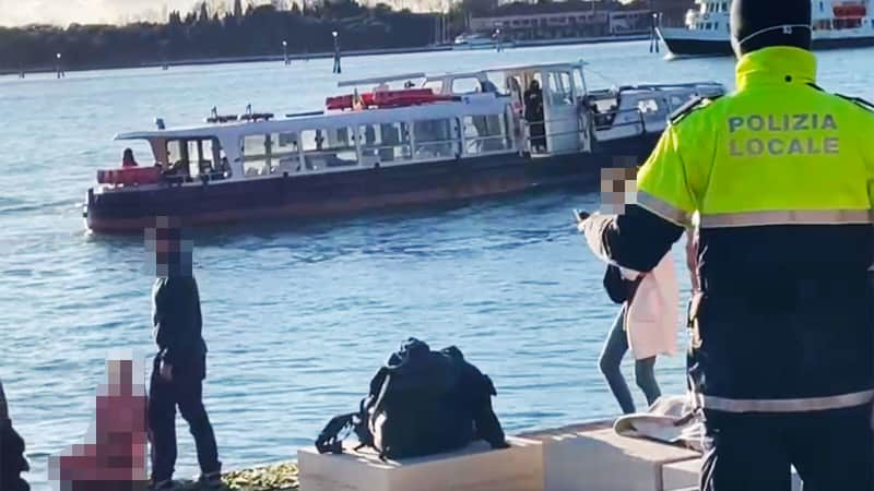 The woman took a dip in the icy water before posing topless for photos on the war memorial. CNN has blurred portions of this image to protect the identities of individuals in the photo.