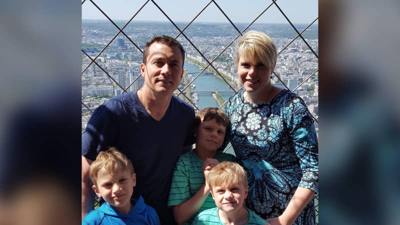 The couple posed for a photo at the top of the Eiffel Tower with their three sons.