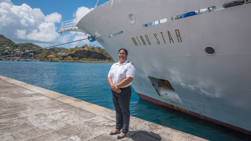 Belinda Bennett in front of the Wind Star, the luxury sailing cruise ship she took the helm of in 2016.