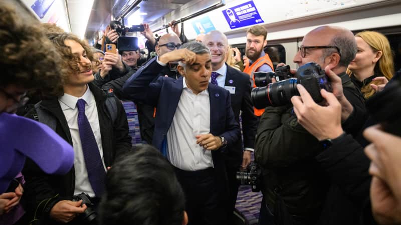 London Mayor Sadiq Khan pretends to mop his brow with relief as the first Elizabeth line trains leave on time. 
