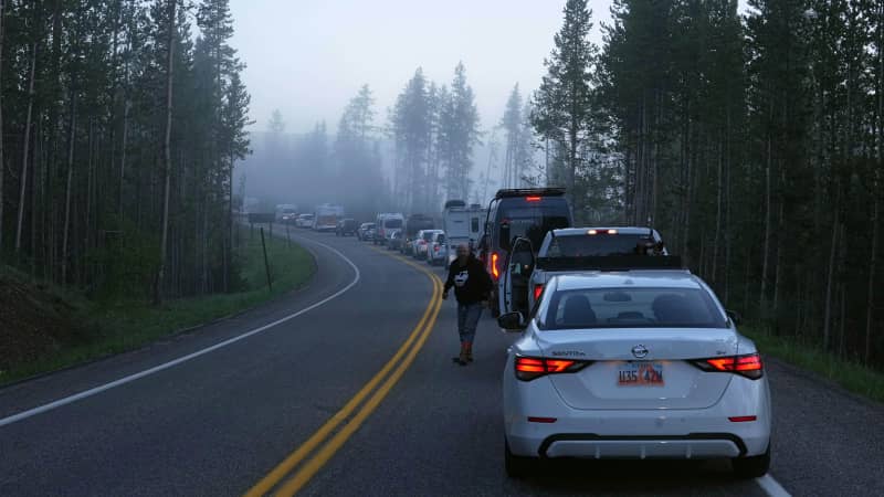 Cars, campers and trucks lined up before sunrise Wednesday outside the south entrance of Yellowstone National Park waiting to gain entry for the first time in more than a week.