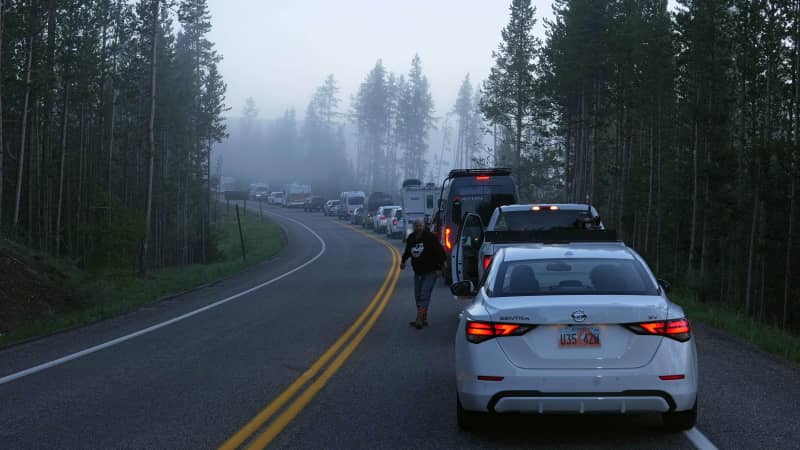 Cars, campers and trucks lined up before sunrise Wednesday outside the south entrance of Yellowstone National Park waiting to gain entry for the first time in more than a week.