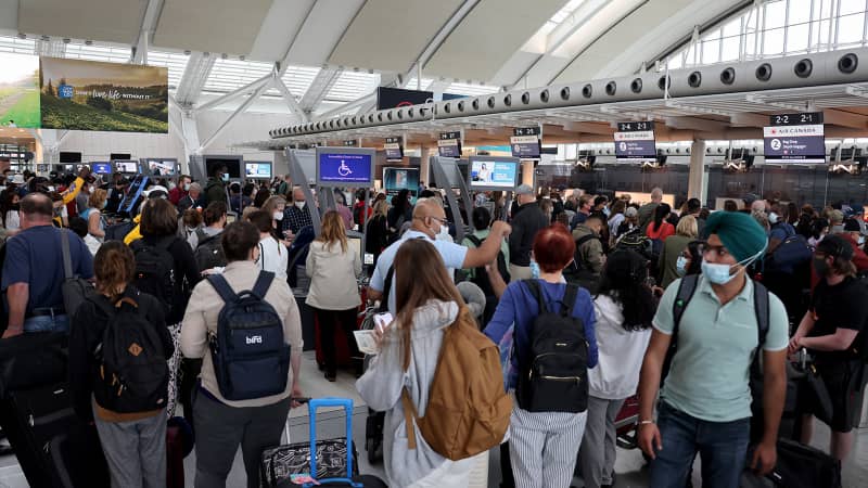 Travelers line up at Toronto Pearson International Airport on June 30, 2022. More than half of the airport's recent flights have been delayed.