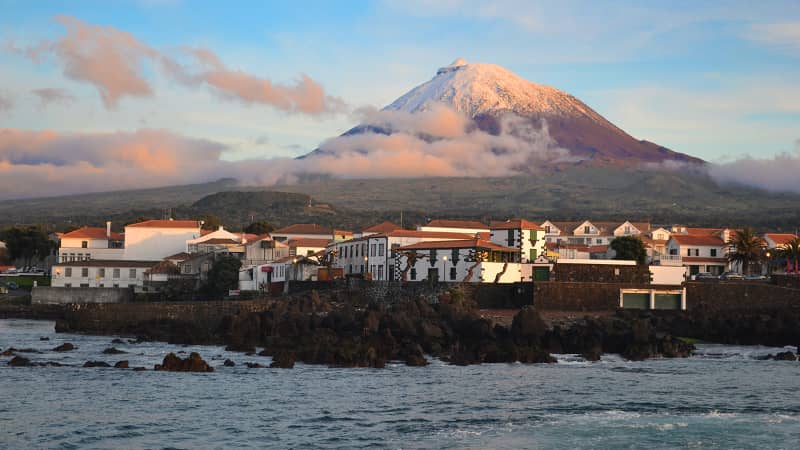 The highest mountain of Portugal isn't on the European mainland. It's the Azores volcano Montanha do Pico on the island of Pico. The village Madalena is seen below at sunset.