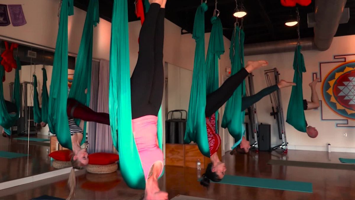 Aerial different inversion antigravity yoga in a hammock Stock Photo by  lenina11only