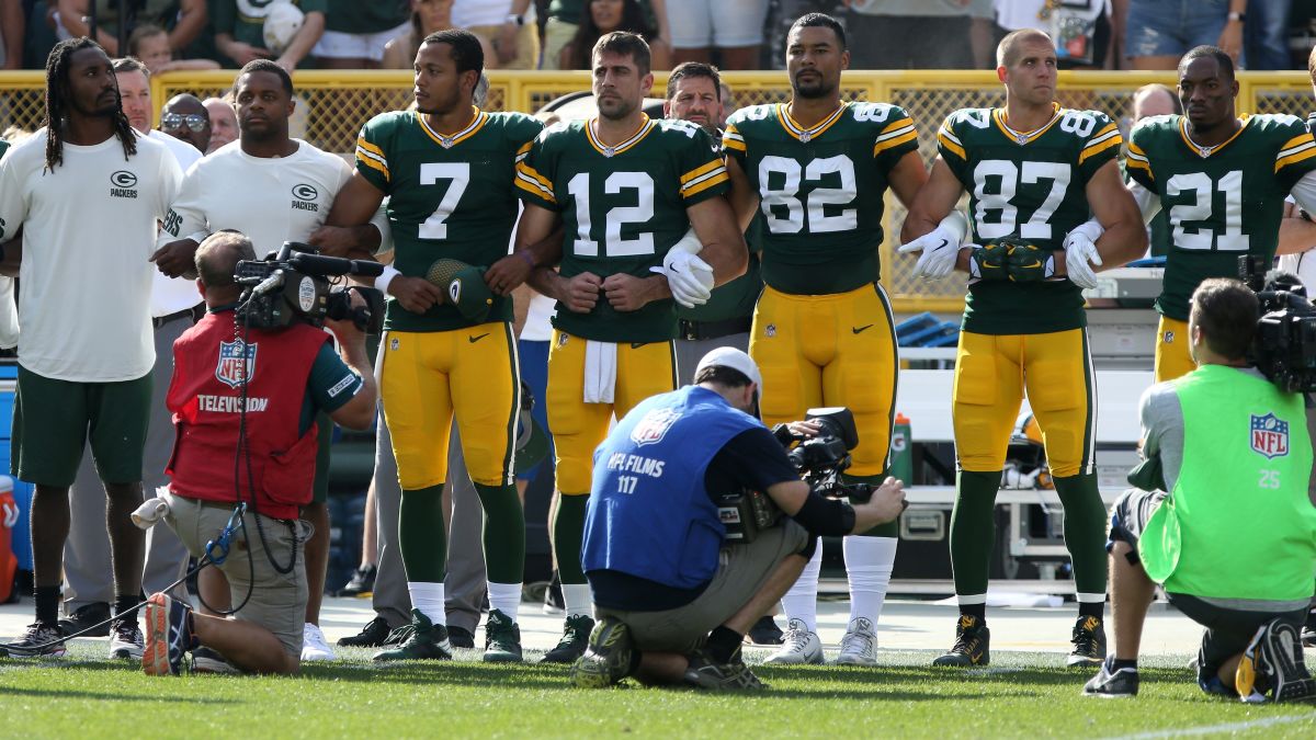 Green Bay Packers' fans who became owners stand with team