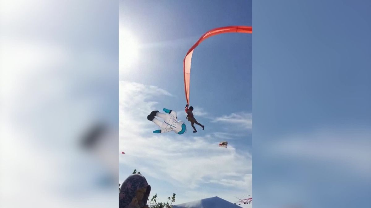 Asian girl caught in kite