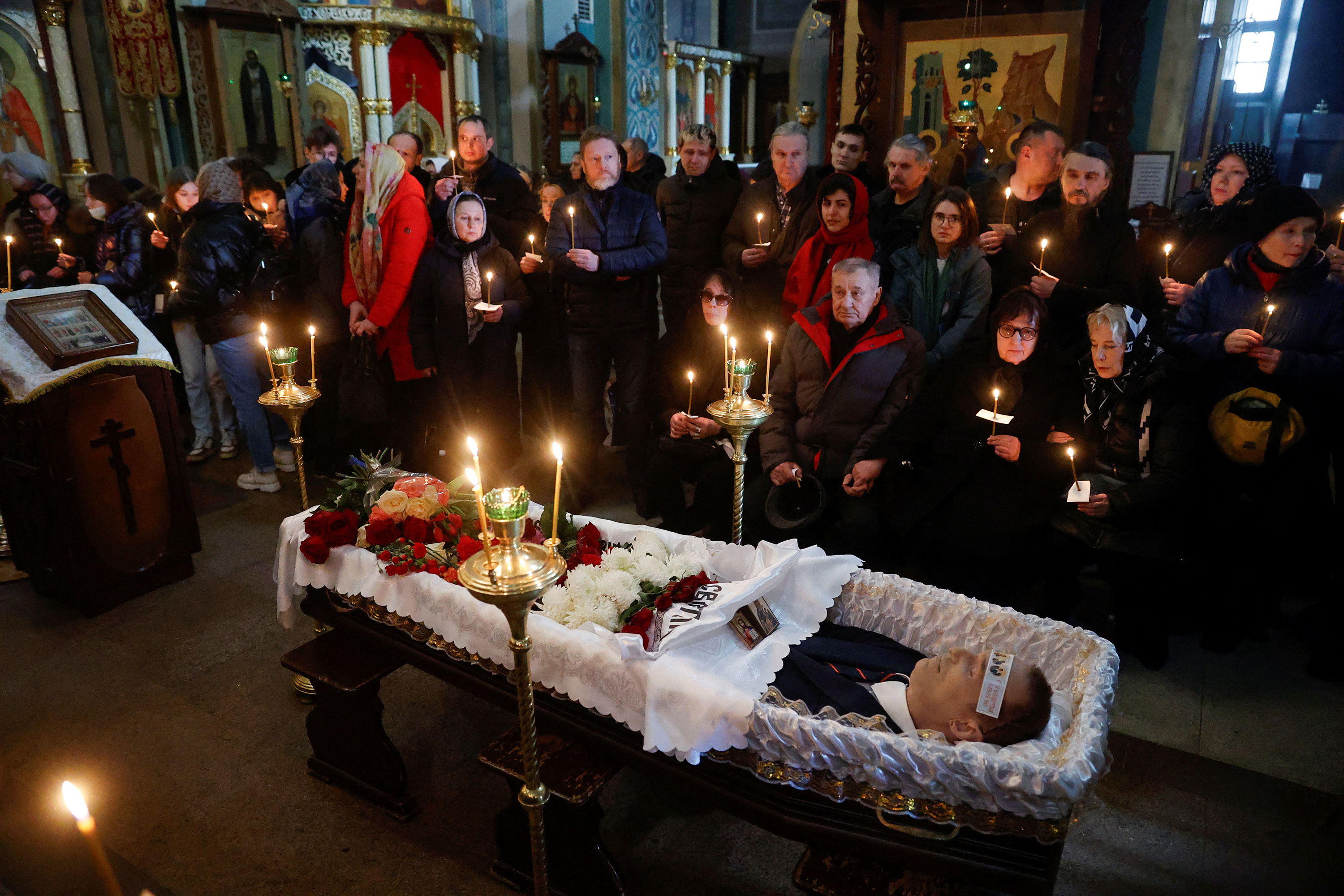 Alexey Navalny's parents, third and fourth from right, and mourners attend his funeral service at the Church of the Icon of the Mother of God 'Quench My Sorrows' in Moscow on Friday.